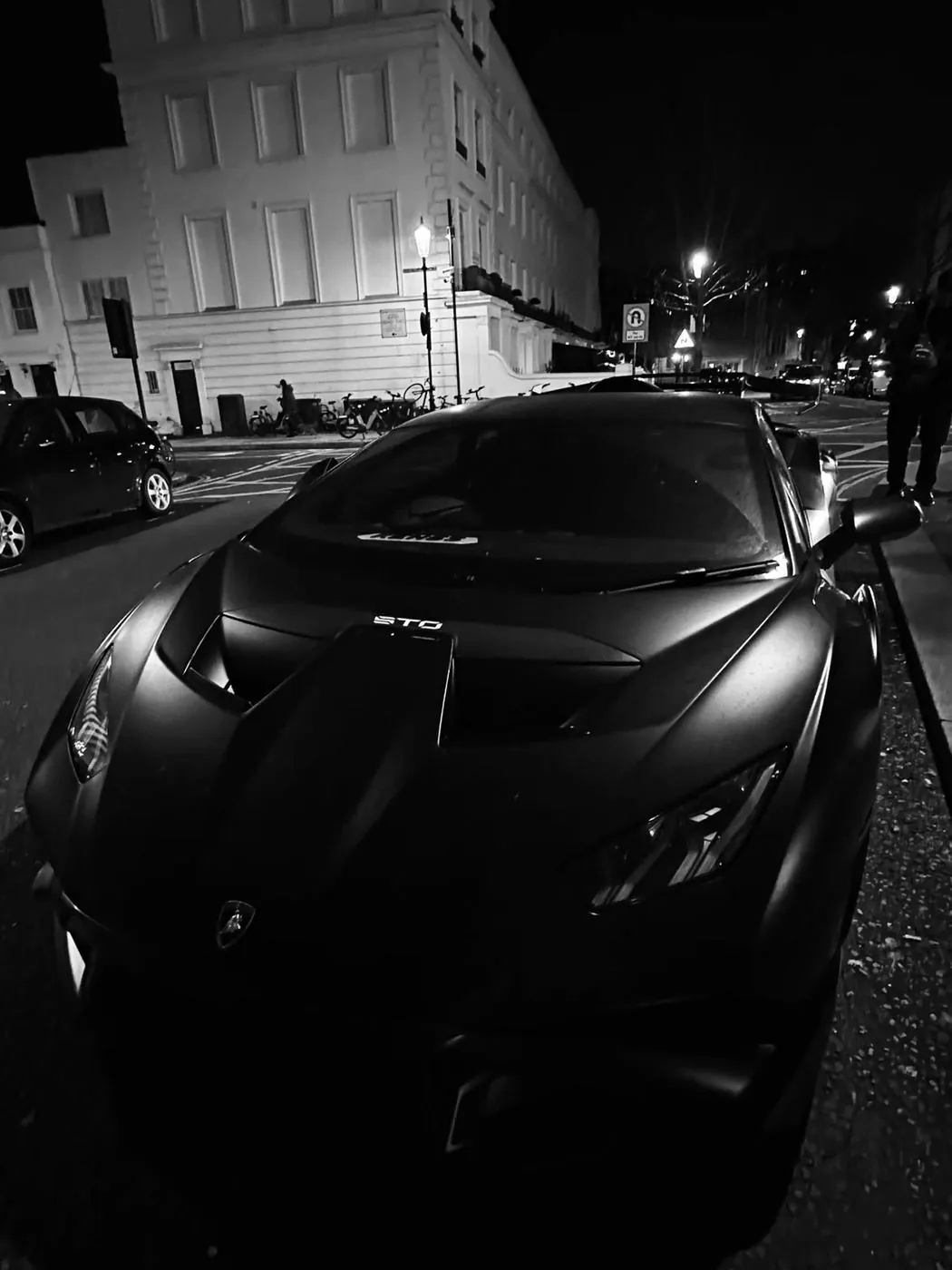 Auto deportivo negro de noche con reflejos definidos, comparación con un auto mal pulido
